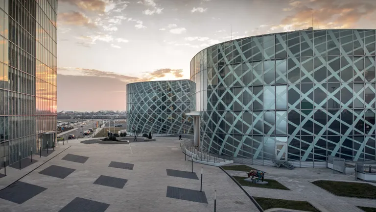 Petrom City headquarters seen from the site, with golden sky at dusk