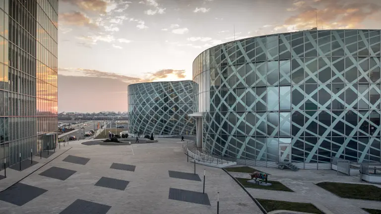 Petrom City headquarters seen from the site, with golden sky at dusk