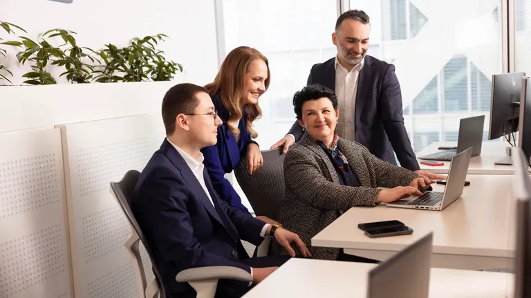 OMV Petrom employees of diverse genders and ages working together in an office