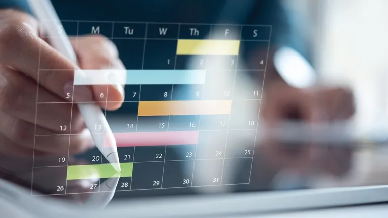 Calendar planner organization management remind, event planning concept. Manager using digital tablet for business and financial events planning on digital calendar planner at office